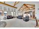 Bright living room with vaulted ceilings and exposed beams offers a seamless transition to the kitchen at 3794 N State Highway 67, Sedalia, CO 80135