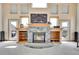 Inviting living room showcases a stone fireplace and built-in shelves, perfect for cozy evenings at 3794 N State Highway 67, Sedalia, CO 80135