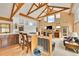 Bright, open living area with vaulted ceilings, wood beams, and a cozy fireplace at 3794 N State Highway 67, Sedalia, CO 80135