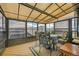 Enclosed sunroom offers a beautiful space with lovely views, perfect for enjoying the outdoors year-round at 3794 N State Highway 67, Sedalia, CO 80135