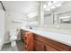 Bathroom with wooden cabinets, white countertops, and a white toilet at 1441 N Humboldt St # 204, Denver, CO 80218