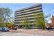 Exterior view of apartment building surrounded by mature trees and greenery at 1441 N Humboldt St # 204, Denver, CO 80218