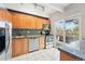 Modern kitchen features stainless steel appliances, granite countertops, and direct access to an outdoor balcony at 1441 N Humboldt St # 204, Denver, CO 80218