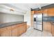 Well-appointed kitchen with stainless steel refrigerator, tiled floors and countertops, adjacent to living area at 1441 N Humboldt St # 204, Denver, CO 80218
