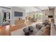 Cozy living room features hardwood floors, large TV, and flows into dining area with outdoor access at 1441 N Humboldt St # 204, Denver, CO 80218