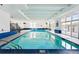 Bright indoor pool with tiled floors and ample natural light from large windows at 1441 N Humboldt St # 204, Denver, CO 80218