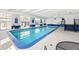 Indoor swimming pool with large windows, tiled floors, and a staircase to an upper level at 1441 N Humboldt St # 204, Denver, CO 80218