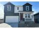 Charming two-story home featuring a brick facade, covered porch, and a two-car garage at 3351 N Buchanan Way, Aurora, CO 80019