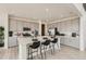 Spacious kitchen with gray cabinets, a large central island with seating, and stainless steel appliances at 3351 N Buchanan Way, Aurora, CO 80019