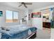 Spacious bedroom with a queen bed, scenic views, and bathroom access at 9667 Walden St, Commerce City, CO 80022