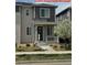 Two-story home featuring stone accents, a covered porch, and a landscaped front yard in a residential neighborhood at 9667 Walden St, Commerce City, CO 80022