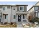 Inviting two-story home featuring a covered porch, stone accents, and neutral-toned siding at 9667 Walden St, Commerce City, CO 80022