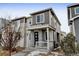 Attractive two-story house with a cozy front porch and a combination of siding and stone at 9667 Walden St, Commerce City, CO 80022