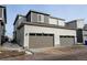Exterior shot showing the garages of this two-story home featuring neutral tone sidings at 9667 Walden St, Commerce City, CO 80022