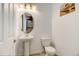 Clean half bathroom with a pedestal sink, oval mirror, and contemporary fixtures at 9667 Walden St, Commerce City, CO 80022