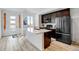 Modern kitchen boasts stainless steel appliances, quartz countertops and ample cabinet space at 9667 Walden St, Commerce City, CO 80022