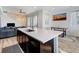 Bright kitchen boasts a center island, modern appliances, and open access to the living area at 9667 Walden St, Commerce City, CO 80022
