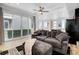 Cozy living room with a plush sofa, ceiling fan, and an open floor plan at 9667 Walden St, Commerce City, CO 80022