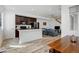Bright open concept living space with a kitchen island, stainless steel appliances, and modern finishes at 9667 Walden St, Commerce City, CO 80022