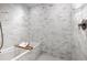 Modern bathroom features marble wall tiles and a soaking tub at 1750 Wewatta St # 830, Denver, CO 80202