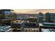 Expansive city view with modern buildings, lush green spaces, and mountain views in the background at 1750 Wewatta St # 830, Denver, CO 80202