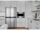 Bright kitchen features stainless appliances, white cabinets, and built in microwave at 1750 Wewatta St # 830, Denver, CO 80202