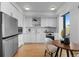 Modern kitchen with stainless steel appliances, marble backsplash, and eat-in breakfast area at 1750 Wewatta St # 830, Denver, CO 80202