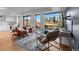 Bright living room featuring hardwood floors, large windows showcasing city views, and comfortable contemporary furniture at 1750 Wewatta St # 830, Denver, CO 80202