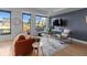 Stylish living area features expansive windows with city views, hardwood floors, and comfortable contemporary seating arrangement at 1750 Wewatta St # 830, Denver, CO 80202