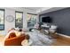 A modern living room with large windows offering city views and contemporary furnishings for a cozy atmosphere at 1750 Wewatta St # 830, Denver, CO 80202