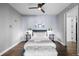 Comfortable main bedroom with dark wood floors, ceiling fan, and modern decor at 1750 Wewatta St # 830, Denver, CO 80202
