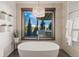 Bright bathroom features an oval soaking tub with stunning mountain views and modern decor at 85 Uncle Sam Lode, Breckenridge, CO 80424