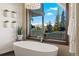 Luxurious bathroom with modern tub, chandelier, and scenic mountain view at 85 Uncle Sam Lode, Breckenridge, CO 80424