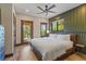 A comfortable bedroom with light walls, natural wood accents, and views of the surrounding forest at 85 Uncle Sam Lode, Breckenridge, CO 80424