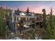 Stunning exterior elevation featuring multiple decks, a hot tub, and panoramic mountain views at sunset at 85 Uncle Sam Lode, Breckenridge, CO 80424