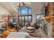 Spacious living room featuring vaulted ceilings, a stone fireplace, and stunning mountain views at 85 Uncle Sam Lode, Breckenridge, CO 80424
