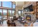 Inviting living room featuring a cozy stone fireplace and gorgeous mountain scenery at 85 Uncle Sam Lode, Breckenridge, CO 80424