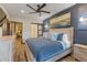 Spacious main bedroom features an ensuite bathroom, wood floors, and decorative accent wall at 85 Uncle Sam Lode, Breckenridge, CO 80424
