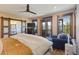 Bright primary bedroom suite featuring a sliding door, comfortable chair and ensuite bath at 85 Uncle Sam Lode, Breckenridge, CO 80424