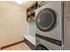 Efficient laundry room with modern stacked washer/dryer, storage and convenient bench at 85 Uncle Sam Lode, Breckenridge, CO 80424