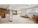 Finished basement with a white sofa, wood paneled walls, and bright natural light at 10475 Tancred St, Northglenn, CO 80234