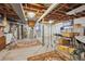 Spacious basement with exposed ceiling, concrete flooring, and storage shelves at 10475 Tancred St, Northglenn, CO 80234