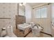 Small bathroom with basic design, tiled floor, and a toilet with grab handles at 10475 Tancred St, Northglenn, CO 80234