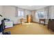 Spacious bedroom with two windows, hardwood floors, and minimal furnishings at 10475 Tancred St, Northglenn, CO 80234