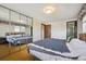 Bedroom boasts a large mirrored closet, natural light, and a queen-sized bed at 10475 Tancred St, Northglenn, CO 80234