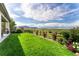 Expansive backyard featuring a lush lawn, lovely fence, and stunning views of the mountains and blue sky at 19429 W 88Th Dr, Arvada, CO 80007
