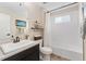 The pristine bathroom features a shower-tub, an updated vanity, and a neutral color palette at 19429 W 88Th Dr, Arvada, CO 80007
