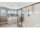 Luxurious bathroom featuring walk-in shower, soaking tub, and stylish finishes at 19429 W 88Th Dr, Arvada, CO 80007