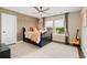 Bright bedroom with decorative accent wall, ceiling fan, and large windows at 19429 W 88Th Dr, Arvada, CO 80007
