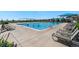 Large community pool surrounded by lounge chairs, perfect for relaxation and recreation at 19429 W 88Th Dr, Arvada, CO 80007